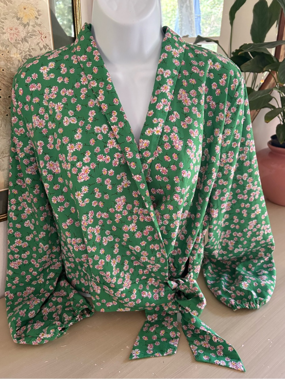 Green floral V-neck top by Vestique a wrap-front style with a tie waist